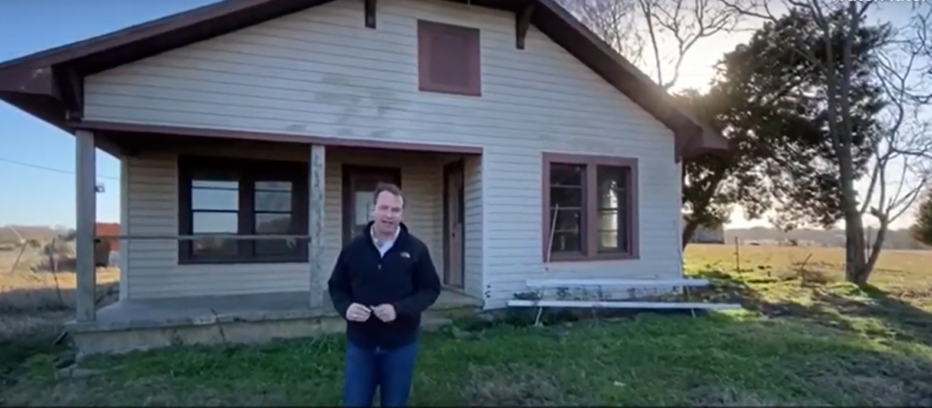 Chris outside an old home