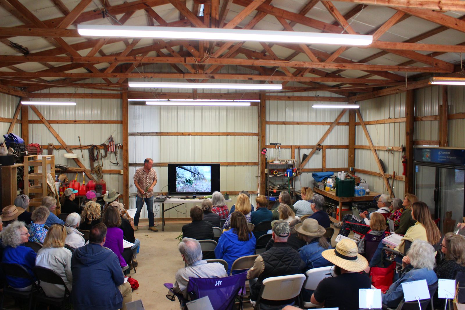Chris Wiesinger speaking to a barn full of gardeners at the 2026 Southern Bulb farm tour